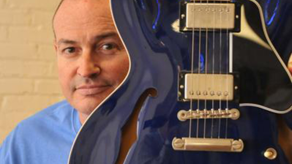 Jay Sieleman poses with a guitar