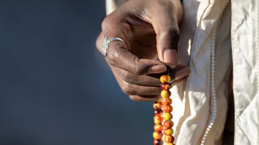Photo of person holding African beads 