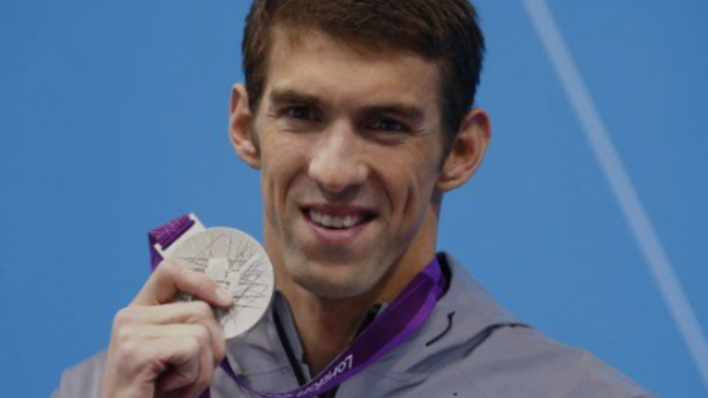 Swimmer Michael Phelps with a silver medal