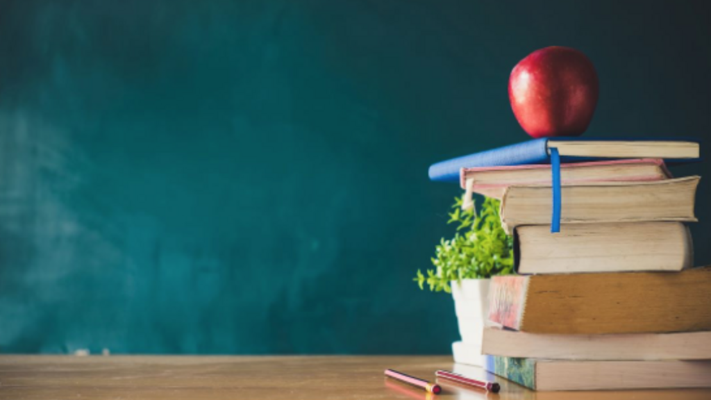An apple sitting on top of a stack of books